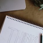 white spiral notebook with pen